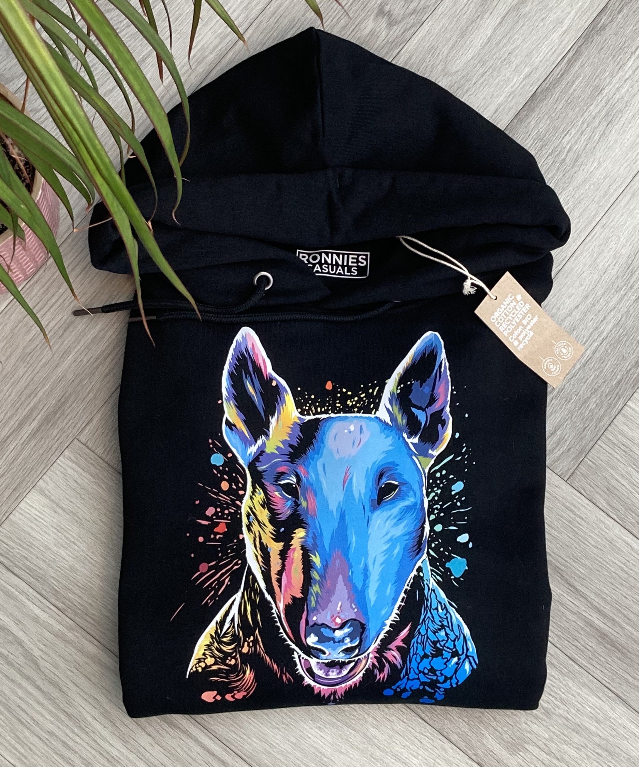 Black Hoodie printed with an English Bull Terrier Dog face in bright colours and paint splashes with a clothes label showing
