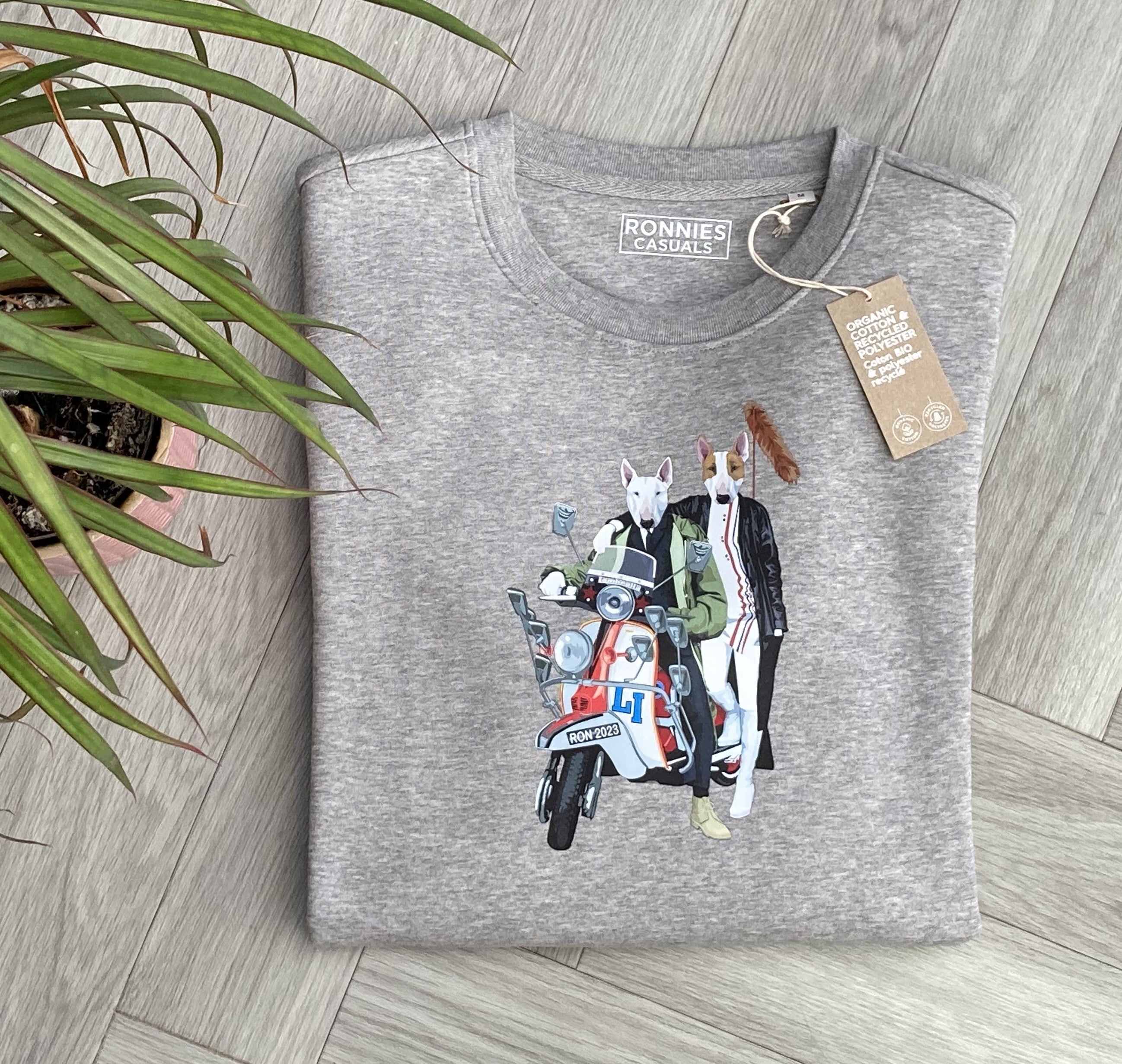 Grey sweatshirt printed with 2 English bull terrier dogs wearing trendy clothes riding a red and white scooter with fox tail on the back